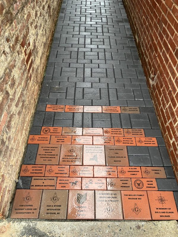 Engraved commemorative bricks in the walkway beside the lodge