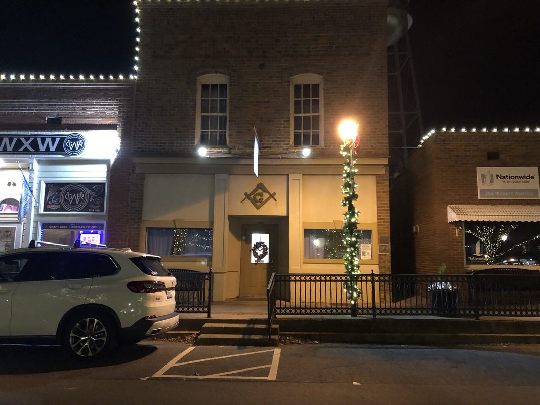 The lodge front at night before the renovation, with the old stucco storefront