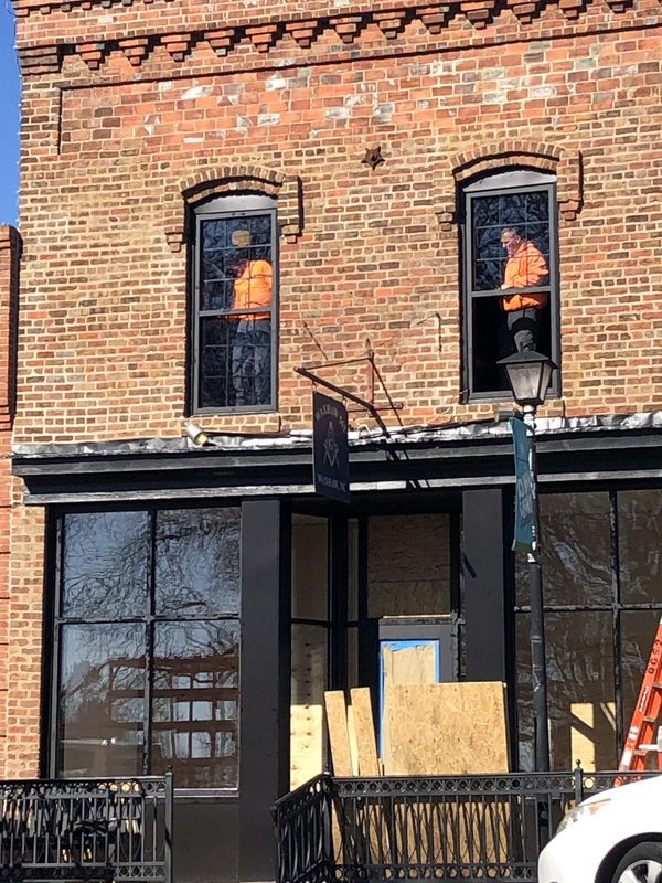 Workers installing the new upper windows on the front of the lodge