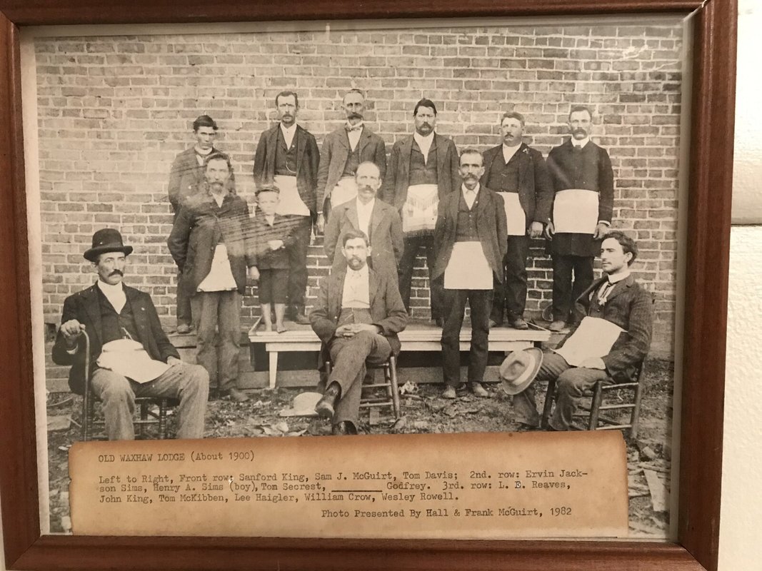 A framed black and white photograph of a group of men, labeled Old Waxhaw Lodge, about 1900
