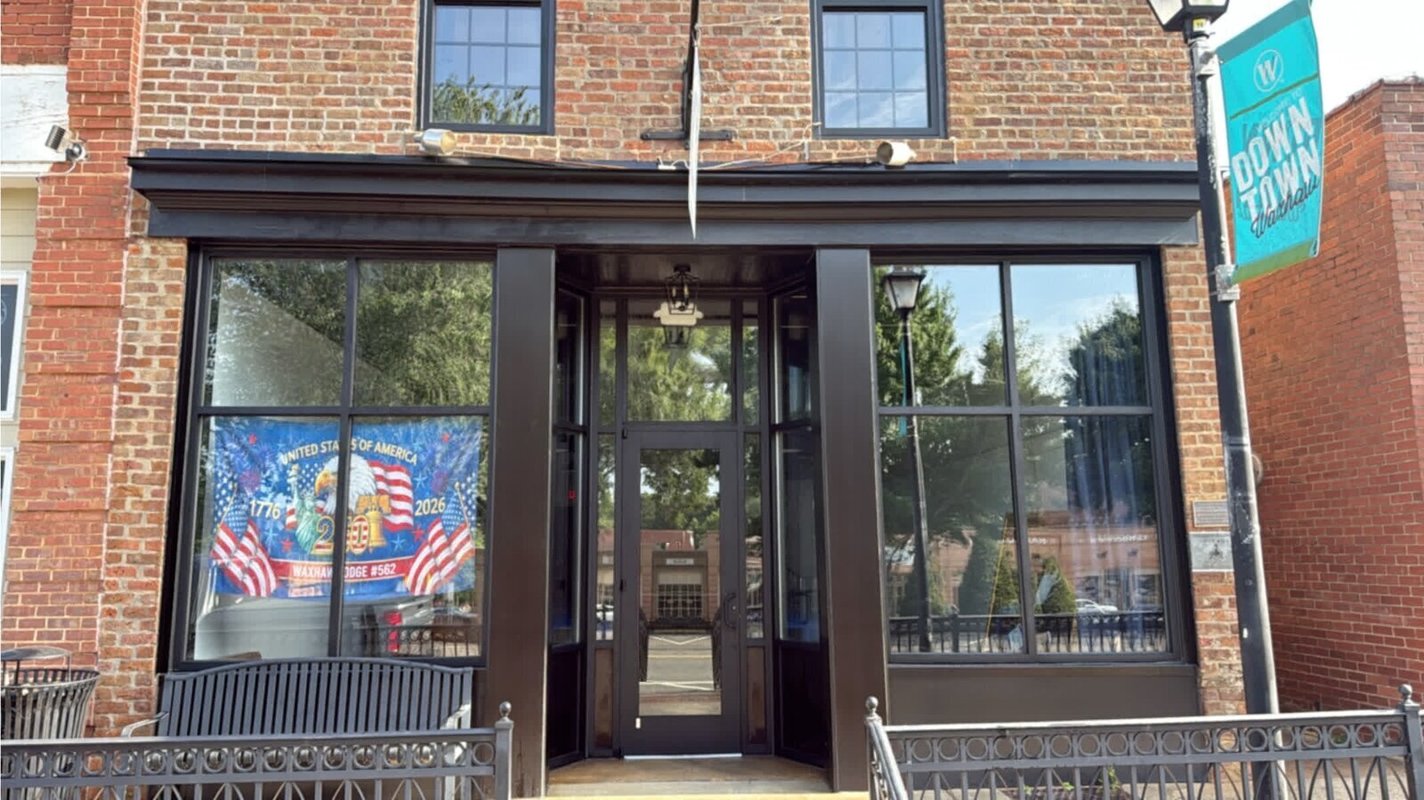 The restored storefront of the Waxhaw Masonic Lodge on Main Street, with a 1776 to 2026 banner in the window